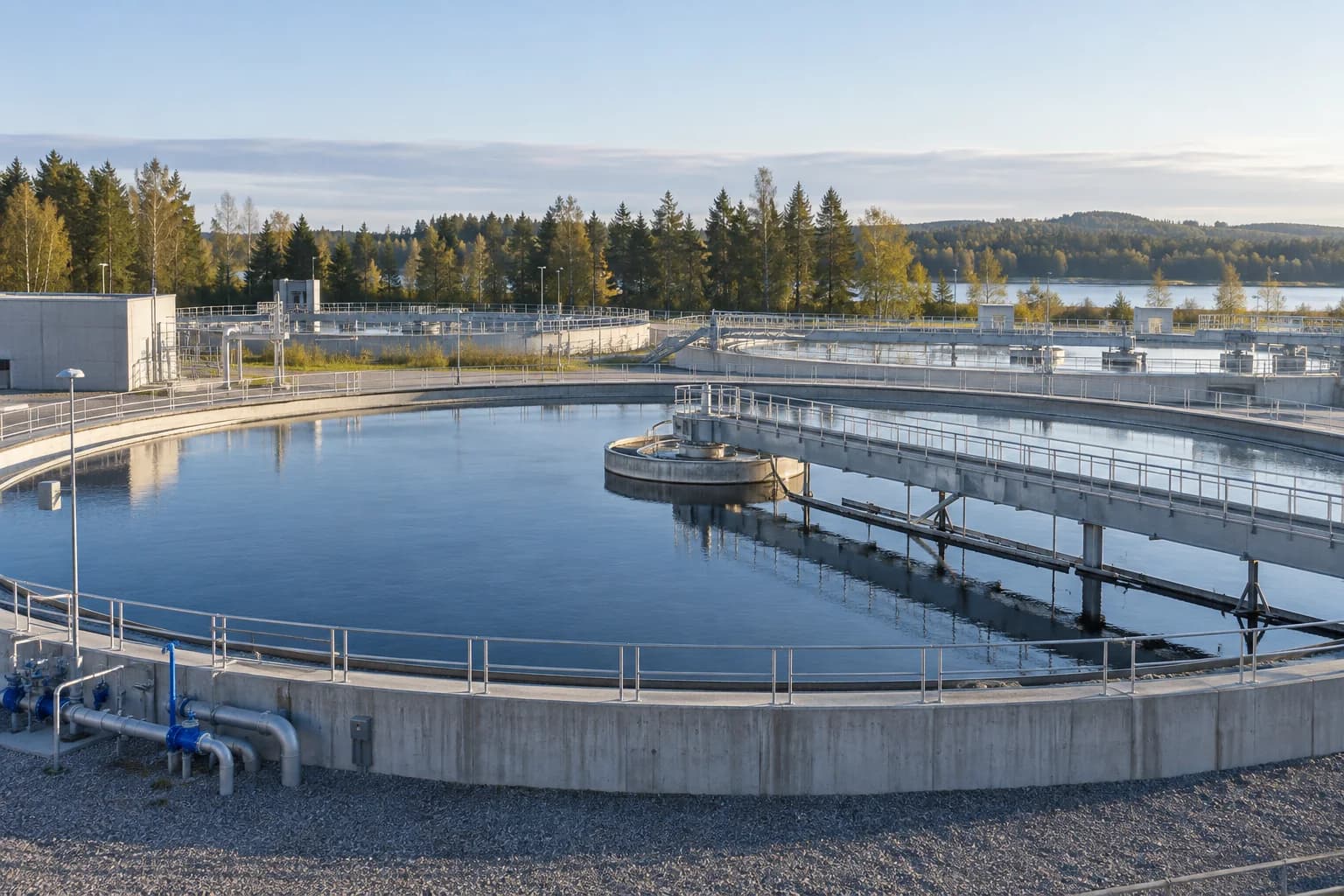 Illustrative water treatment basin with a scraper bridge and perimeter railings